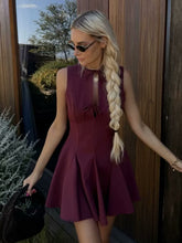 A Sleeveless Dress Decorated With A Bow
